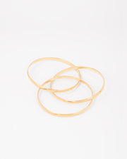 Bracciale rigido Paola in acciaio inossidabile color oro, composto da tre bracciali distinti intrecciati tra loro. Qui viene rappresentato aperto per far vedere l'intreccio. Come sempre è in materiale anallergico e waterproof.